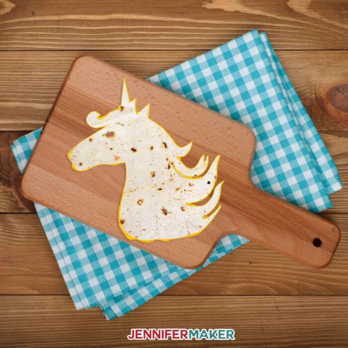 Unicorn shaped tortilla on a wood cutting board makes a Cricut tortilla