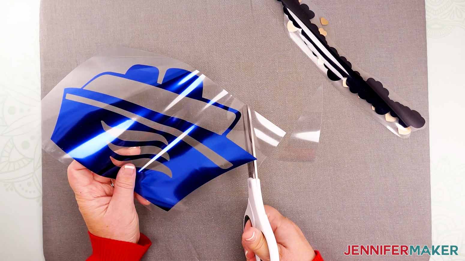 Use scissors to trim away excess liner around foil iron-on design.