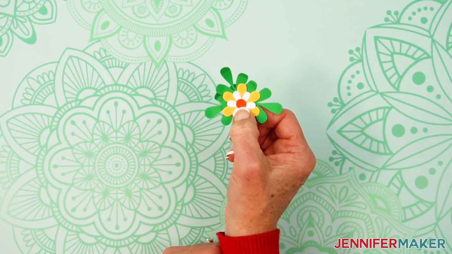 Add the orange center to the top of the white flower and glue it in place.