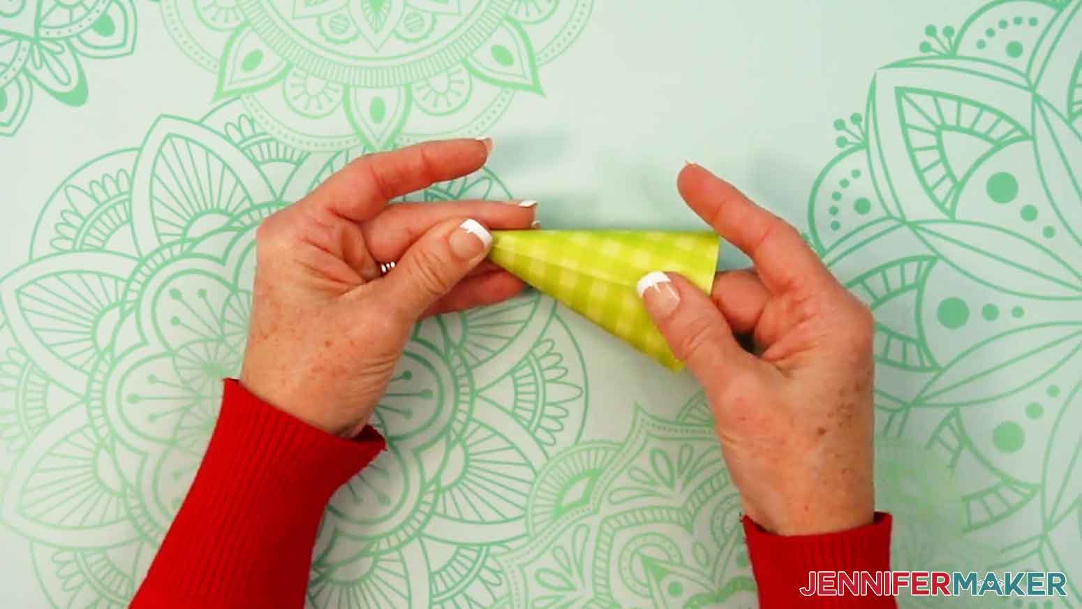Press and hold the edges of the cone-shape together to adhere the gnome hat together.
