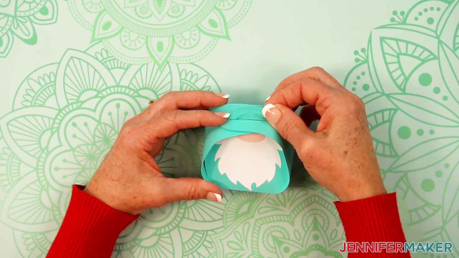 Fold the right side over the top of the handles and pull the handles through the slits.