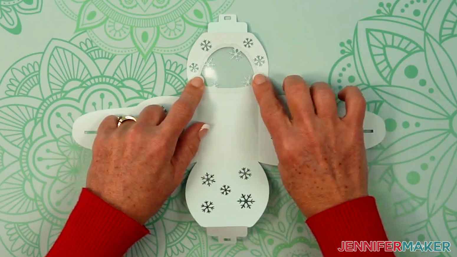 Place the acetate on the cutout and press on the glued edge to adhere it to the cardstock.