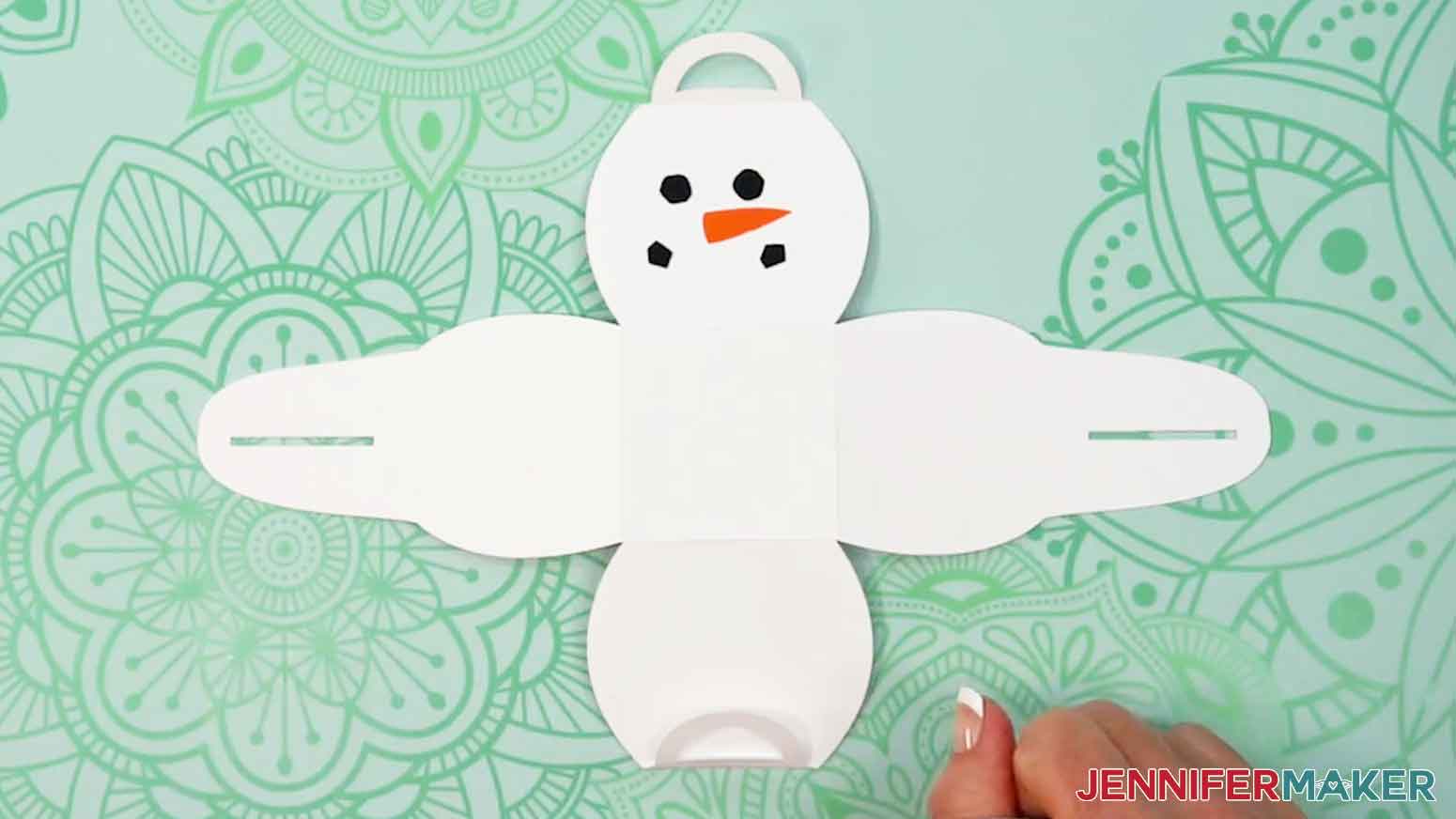 Place the left and right top pieces of the snowman smile.