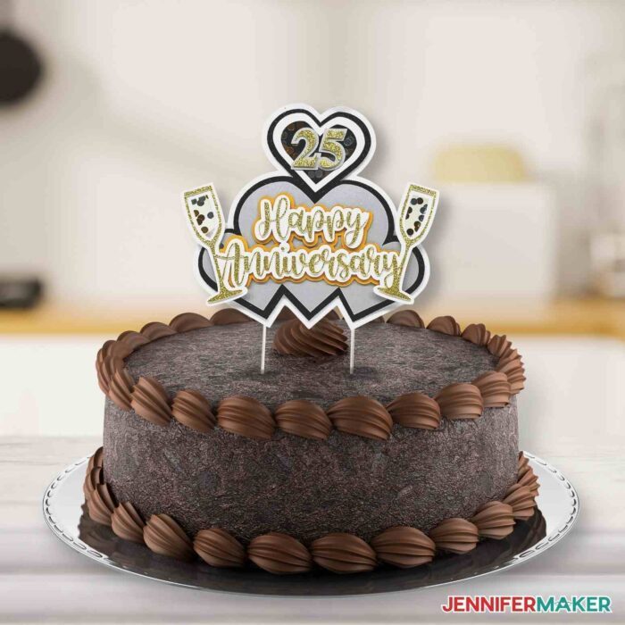 Custom "happy anniversary" cake topper on top of a chocolate cake