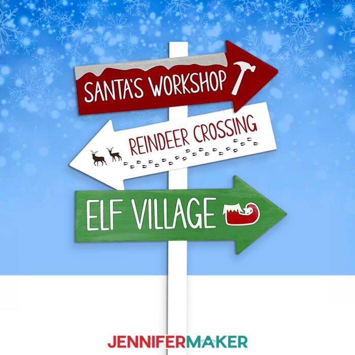 Make a custom family sign post with JenniferMaker's tutorial! A signpost with three arrows reading "Santa's Workshop," "Reindeer Crossing," and "Elf Village" stand against a snowy background.