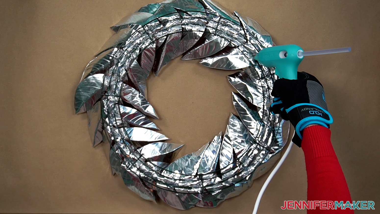 Apply hot glue to the entire backside of the wreath to secure the metal leaves in place.