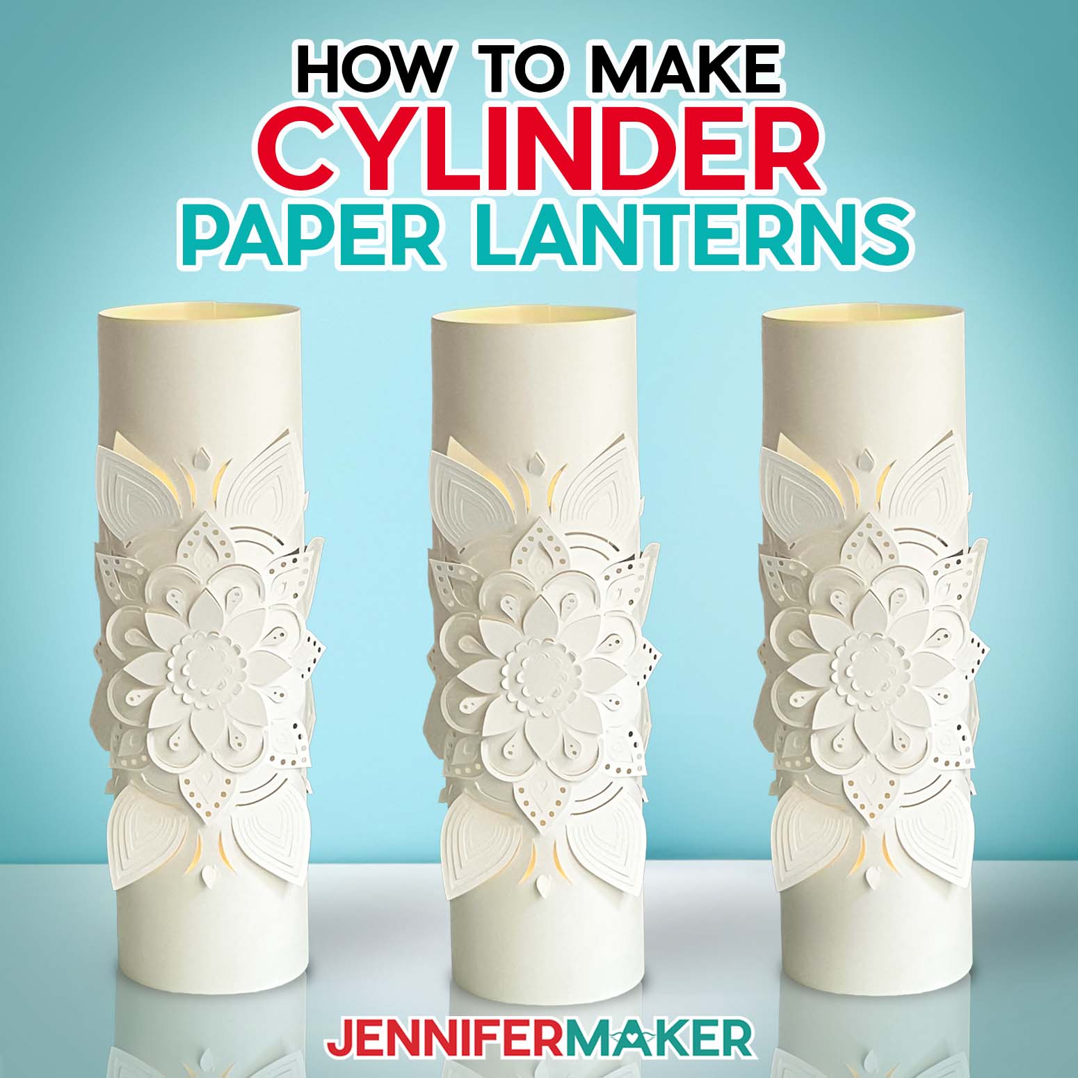 Three white cylinder paper lanterns with intricate cut designs.