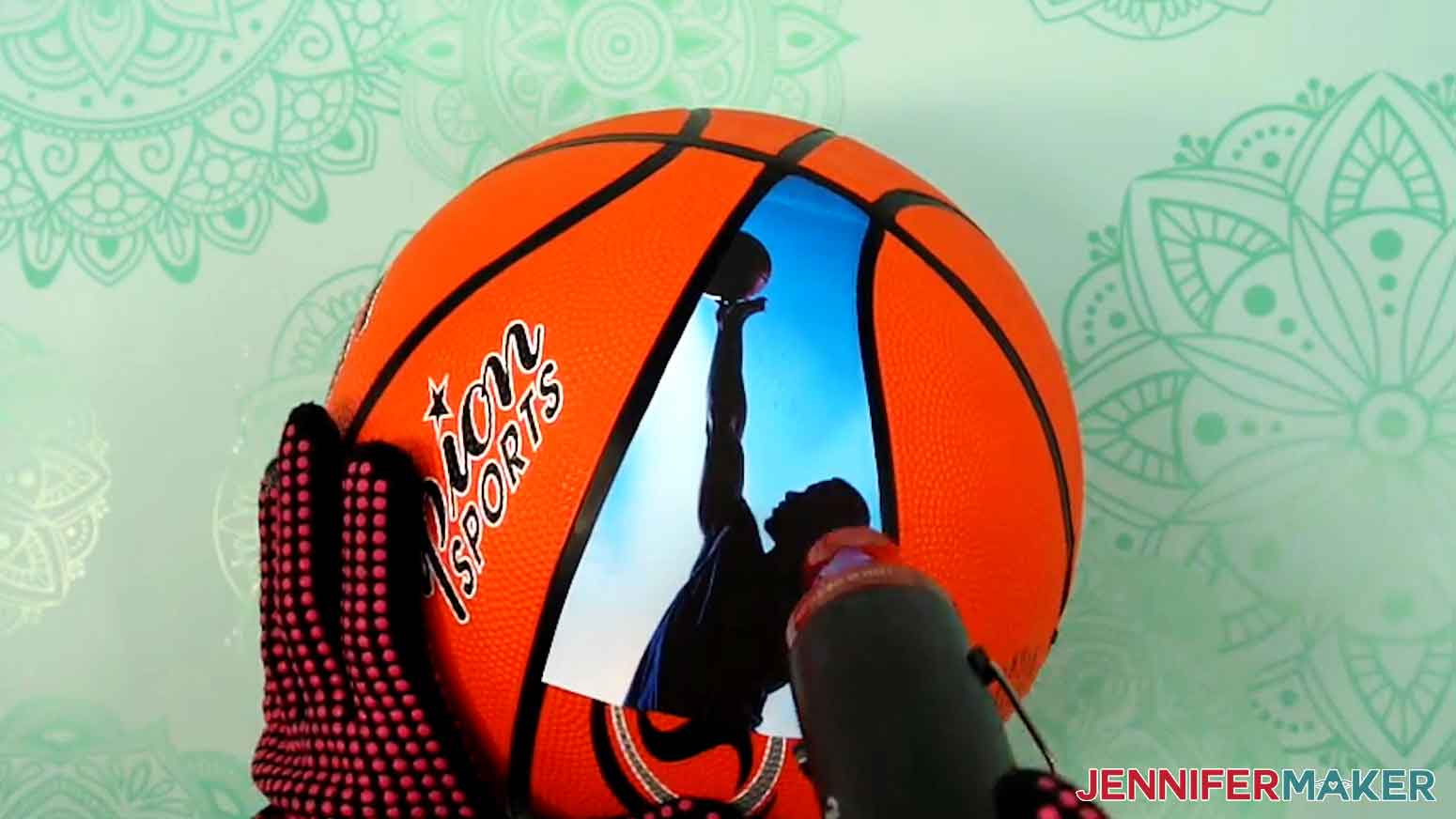 Apply heat to the edges of the printable iron-on vinyl to adhere it to the basketball.