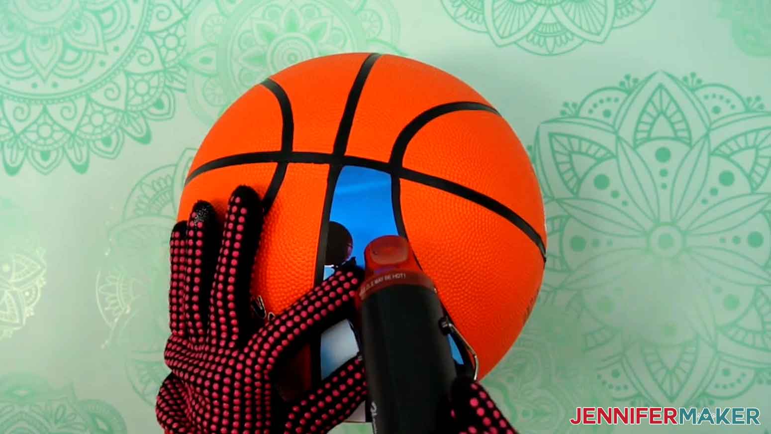 Apply heat to the top of the photo iron-on panel to adhere it to the basketball.