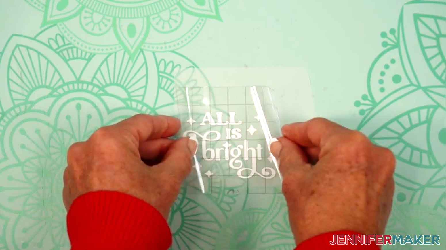 Hold your transfer tape in the shape of a &ldquo;taco&rdquo; sticky side down and lower it onto the vinyl.