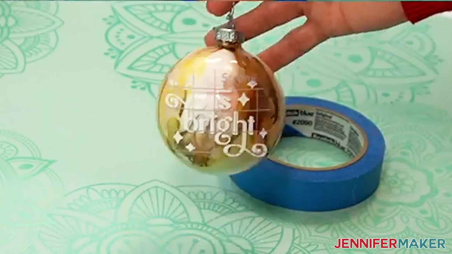 Pick the ornament up by its hanger and look at it straight on, at eye level, to make sure the vinyl is straight.