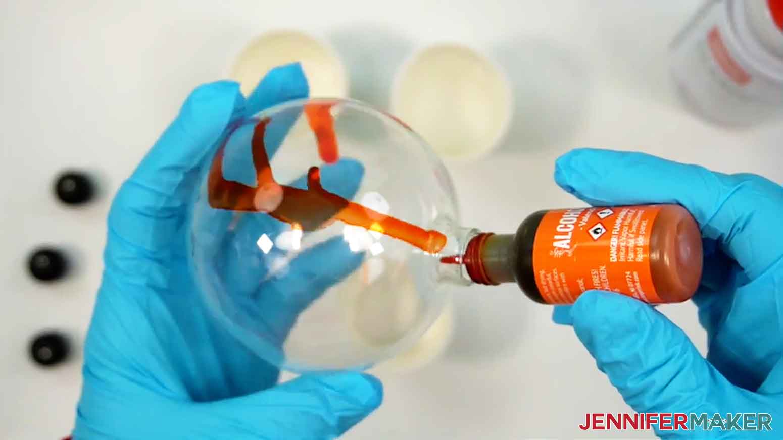 Gently squeeze the bottle of alcohol ink to drip the ink into the ornament.