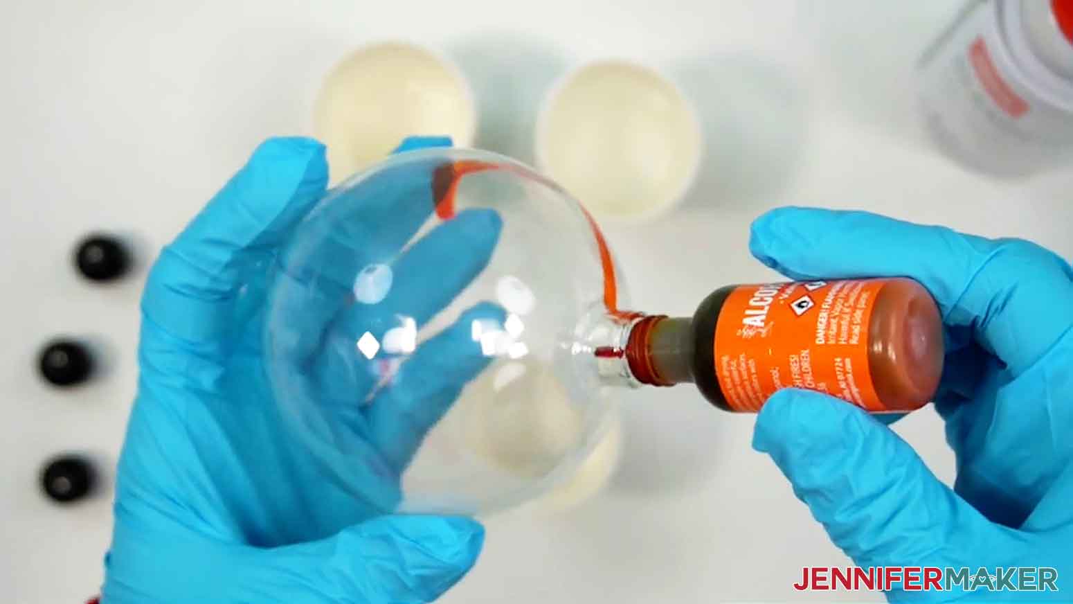 Insert the tip of the orange alcohol ink into the top of the ornament.