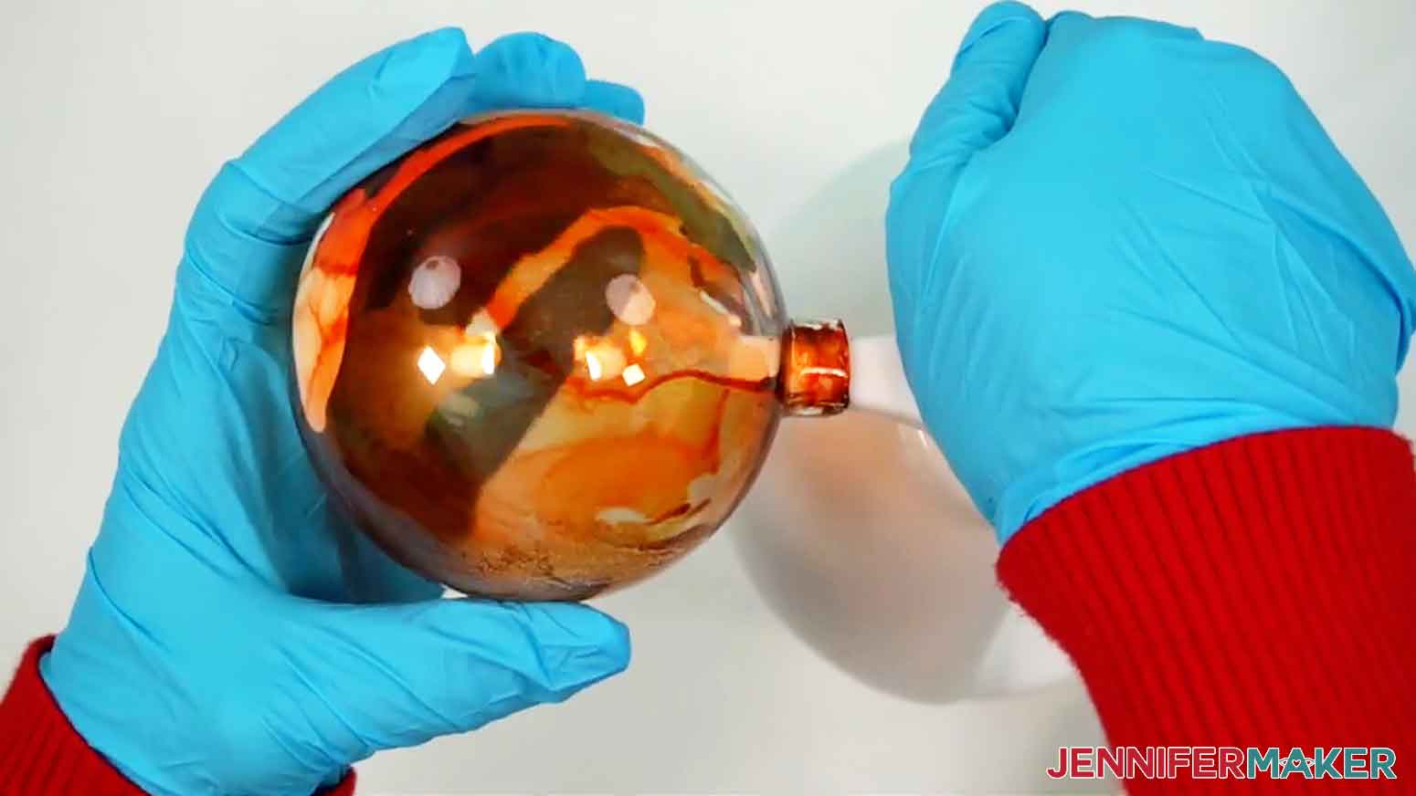 Add three to six pumps of paint to the inside of the ornament, rotating it as you go so the paint is well-distributed.