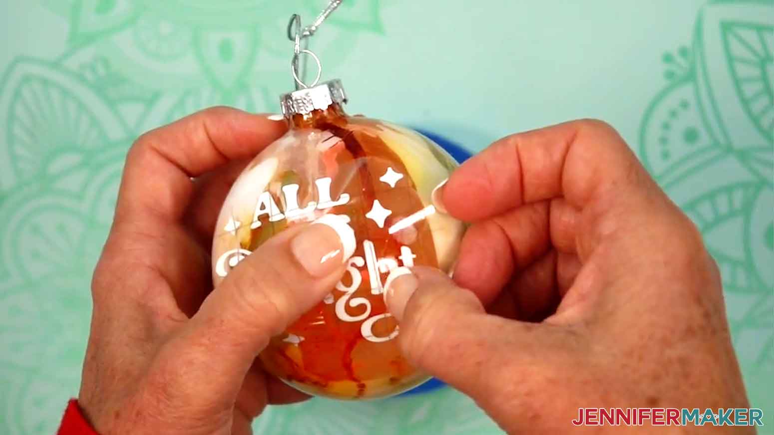 Smooth the decal onto the ornament from the center outward, smoothing out any wrinkles in the vinyl.