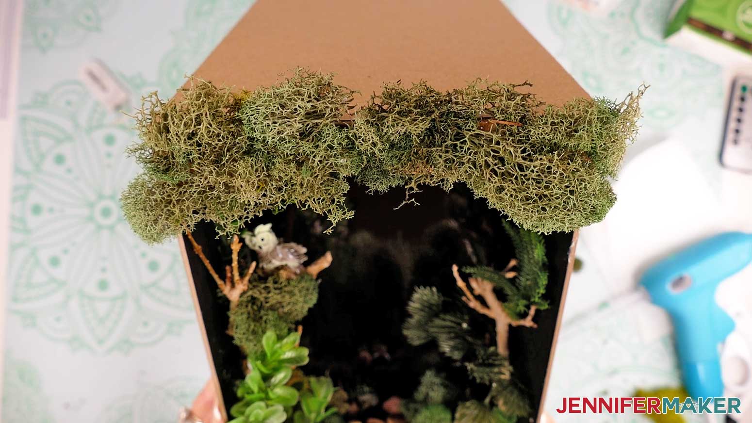 Moss attached to the front arched panel of the diy book nook