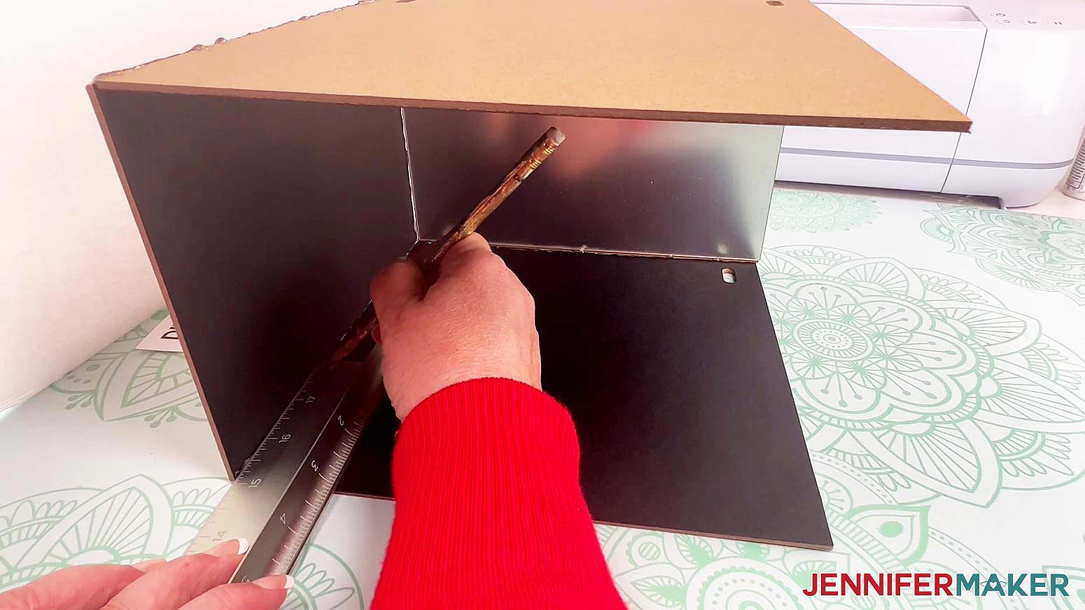 Mark the intended front mirror placement on the inside of the diy book nook box with a ruler and pen or pencil