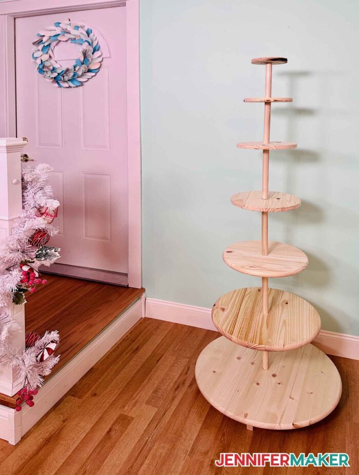 DIY Christmas tree display stand made from wood tabletops and 1" dowels