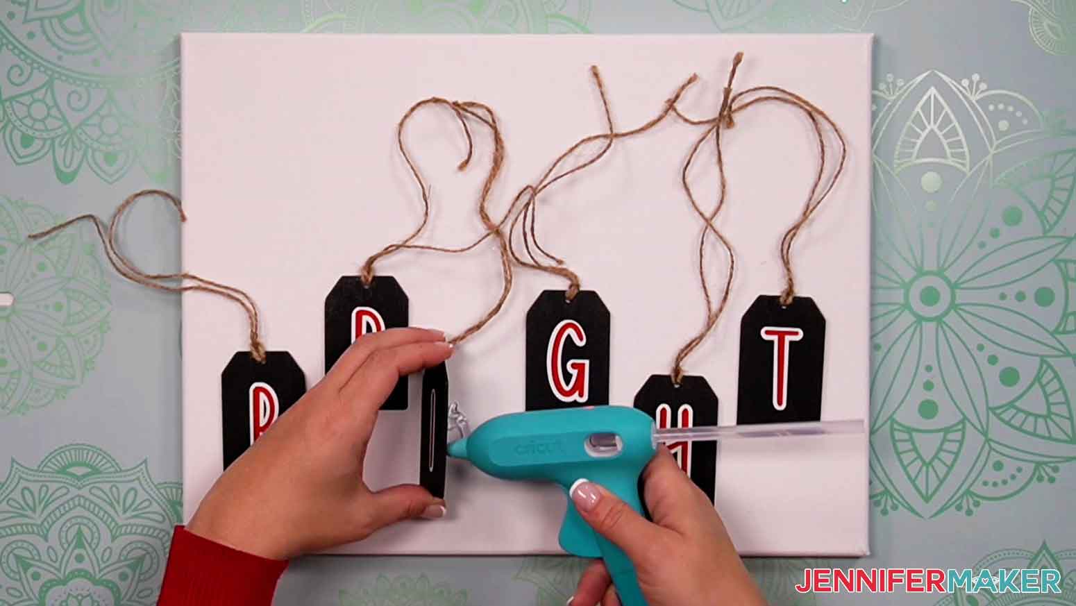 Use a hot glue gun to attach chalkboard tags to the canvas.