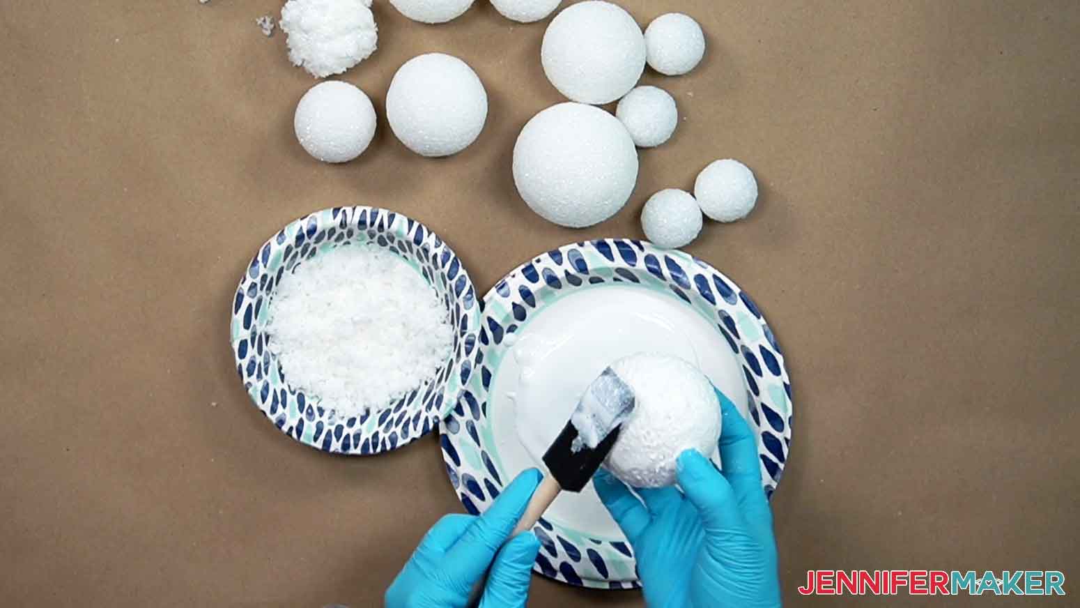 Roll foam craft balls in glitter mod podge and roll in instant snow.