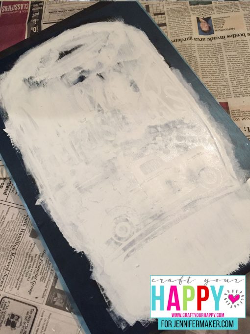 Painting over the stencil for the DIY Christmas Mason Jar Snowglobe Chalkboard Sign