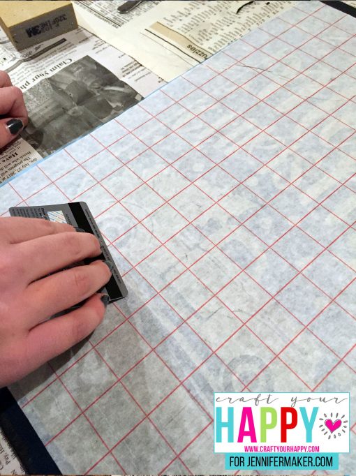 Applying the stencil to the DIY Christmas Mason Jar Snowglobe Chalkboard Sign