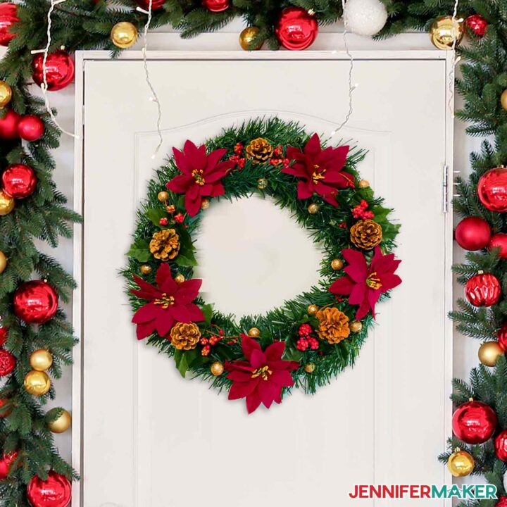 Decorated Dollar Tree wreath with red poinsettias on a white door