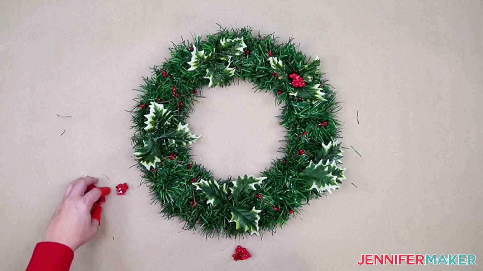 Arrange decoration pieces around wreath before gluing.