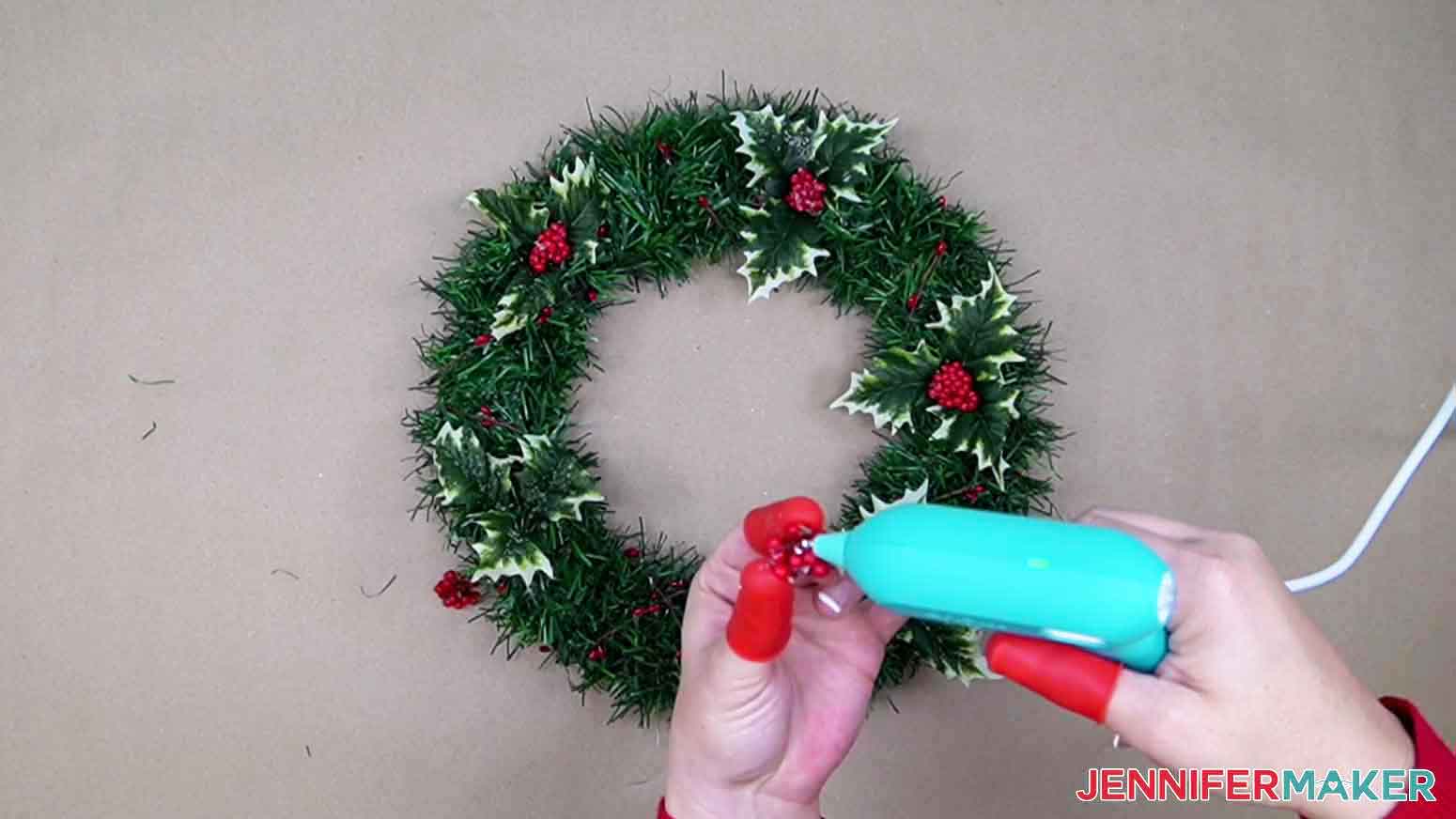Use a hot glue gun to glue decoration pieces to garland.