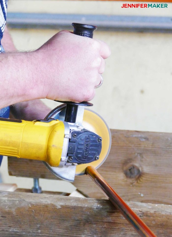 Cutting the copper pipe with a table saw to make DIY copper pipe curtain rods