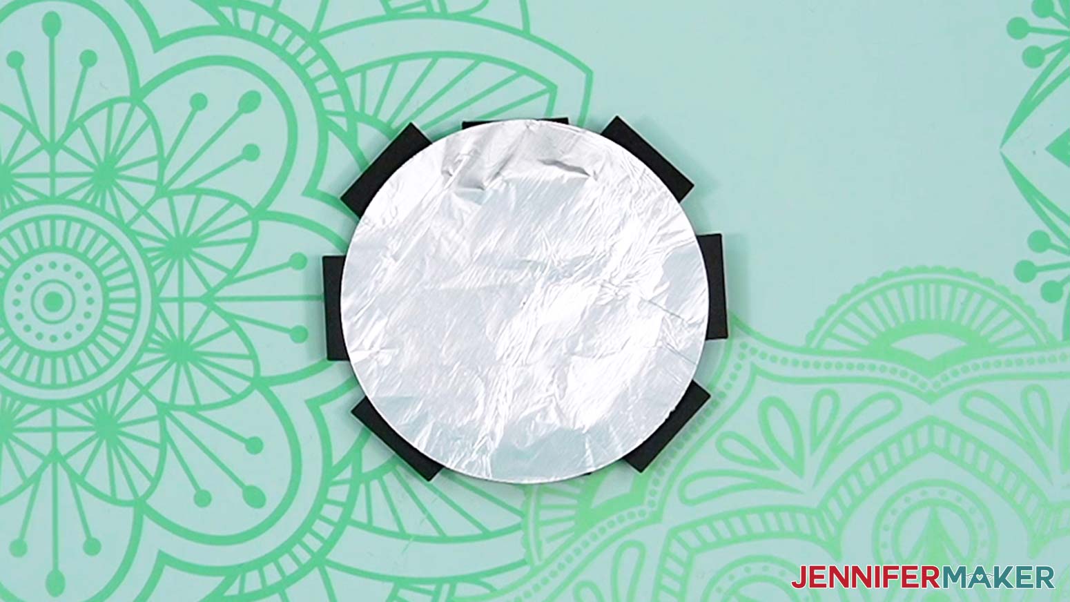 Align the foil circle over the center of the sunburst piece.