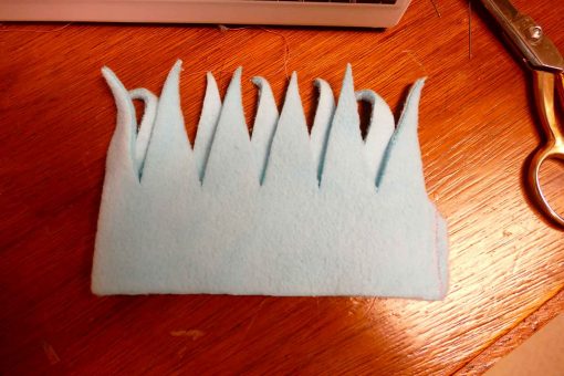 Sew the edge of the fringe top to form a tube