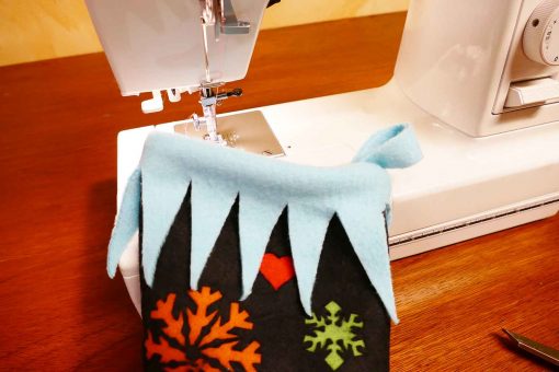 Sew the fringe onto the top of the elf stocking
