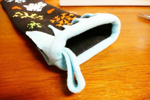 Sew the fringe onto the top of the elf stocking