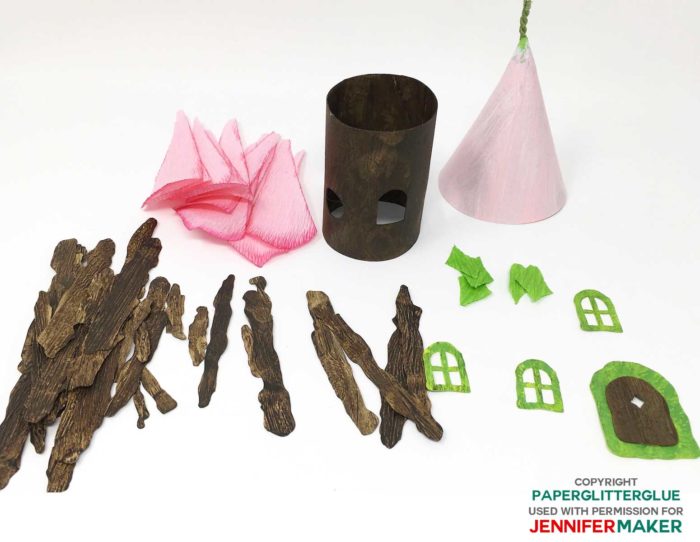 Colored and distressed paper pieces needed to make the DIY fairy house with a flower roof