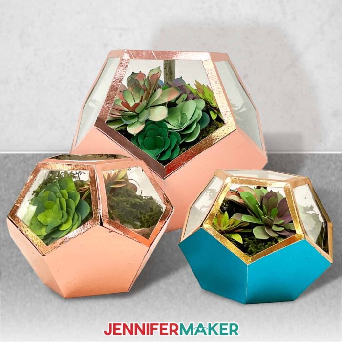 Learn how to make a DIY faux terrarium with JenniferMaker's tutorial! Three small faux terrariums made with metallic and multicolored cardstock, filled with a variety of hand-inked cardstock succulents.