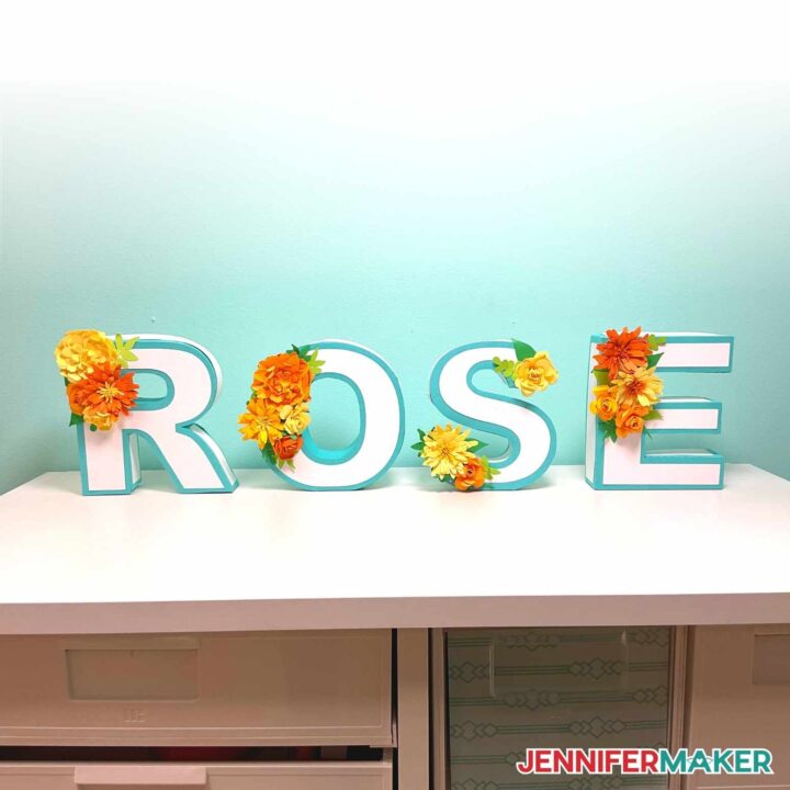 DIY Floral Letters spelling ROSE sitting on a desk.
