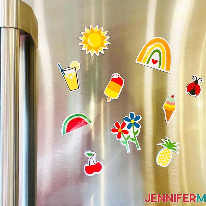 DIY fridge magnets with bright designs of fruits and summery flowers on a stainless steel refrigerator.