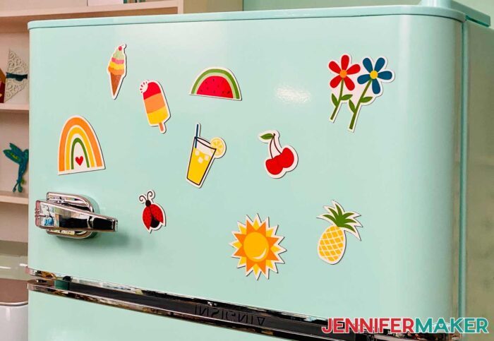 DIY fridge magnets with bright designs of fruits, summer snacks, and a ladybug on a retro mint refrigerator.