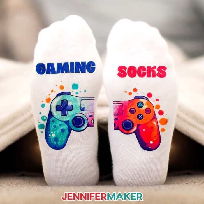 Sublimation socks with a colorful Playstation controller split between the two and "gaming" on one with "socks" on the other.