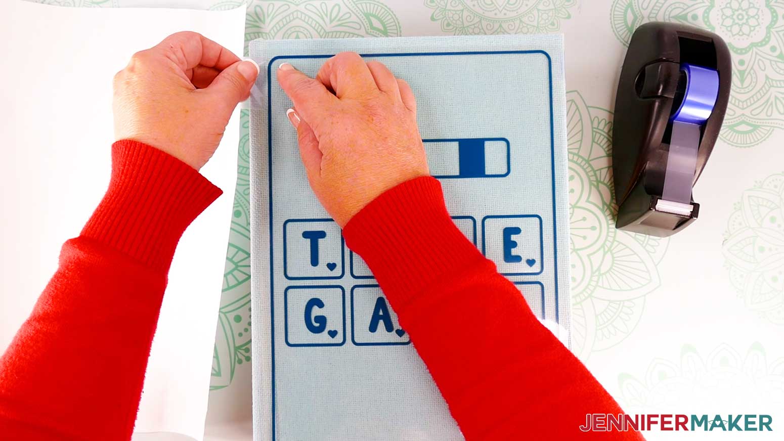 Tape down the carrier sheet&rsquo;s corners with heat resistant tape to keep the decal in place while pressing the board game box