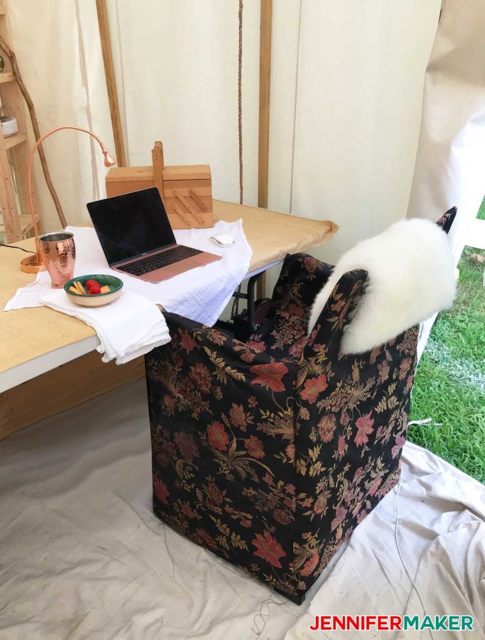 Glamping workspace with upholstered chair and table makes a great DIY glamping idea