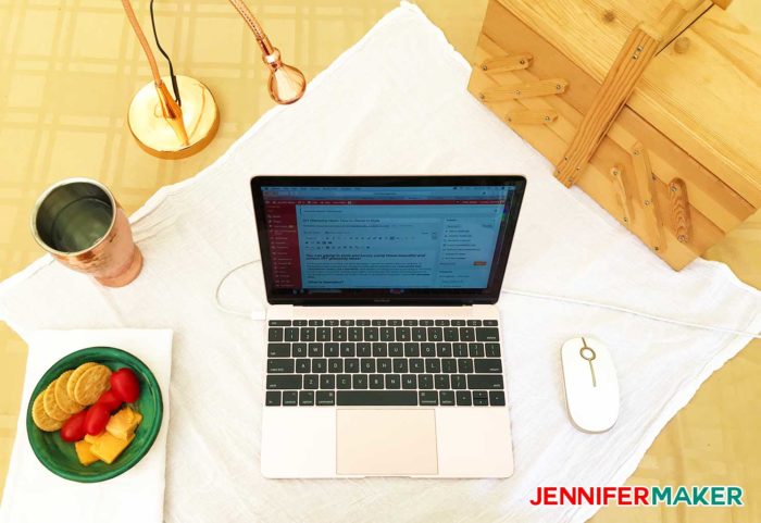 My glamping desk with my rose gold MacBook and copper cup and lamp