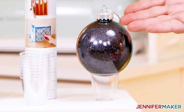 Small plastic cups to keep DIY glitter ornaments stationary for drying and decorating
