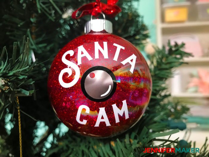 A red glitter ornaments with a Santa Cam decal