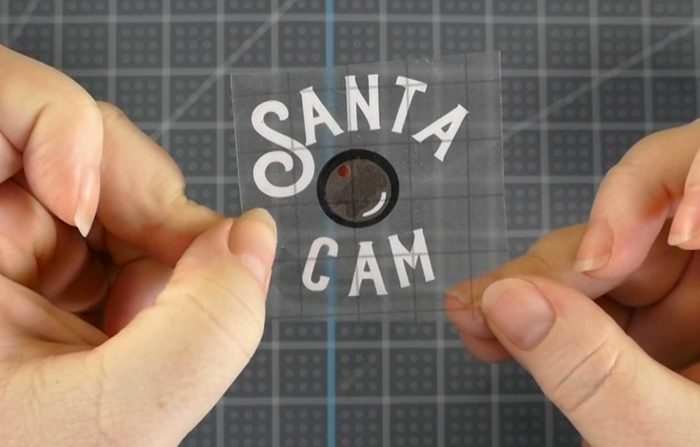 A layered vinyl Santa Cam decal for a DIY glitter ornament