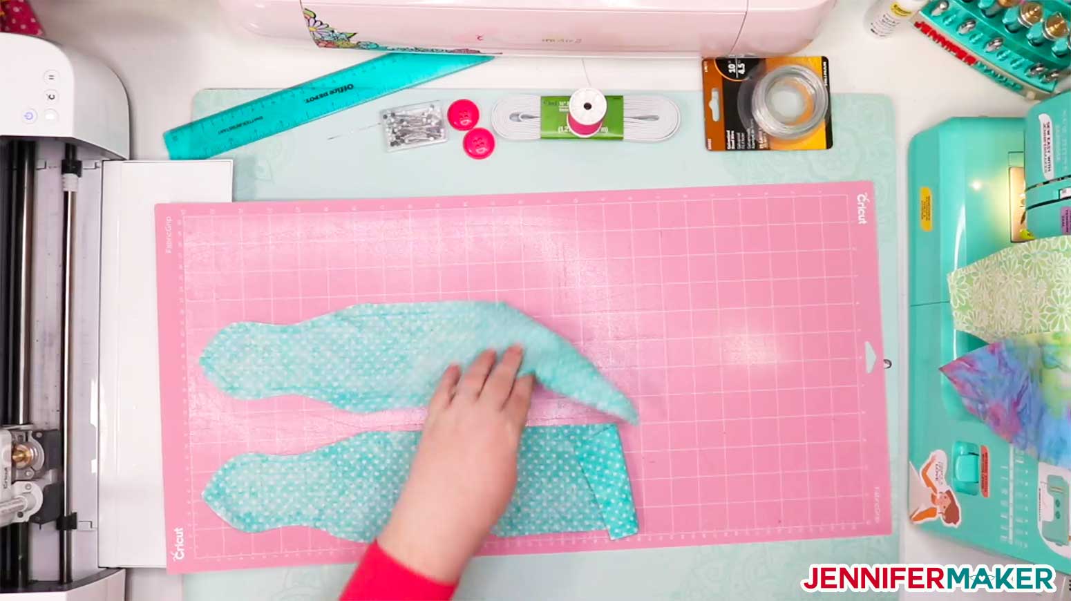 Removing the cut fabric from the pink FabricGrip mat to make DIY headbands with buttons for face masks