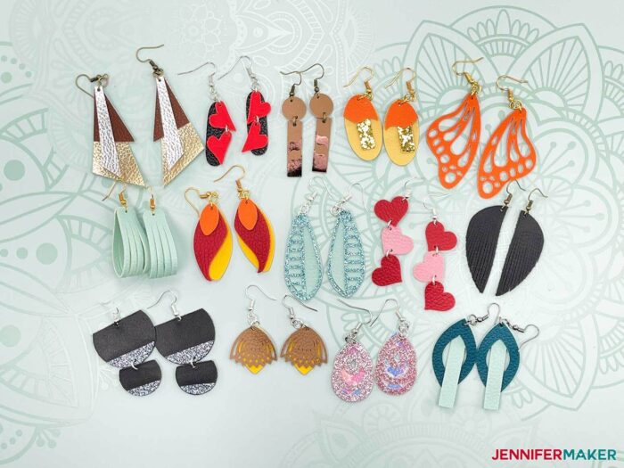 8 pairs of DIY faux leather earrings on a light blue Cricut mat