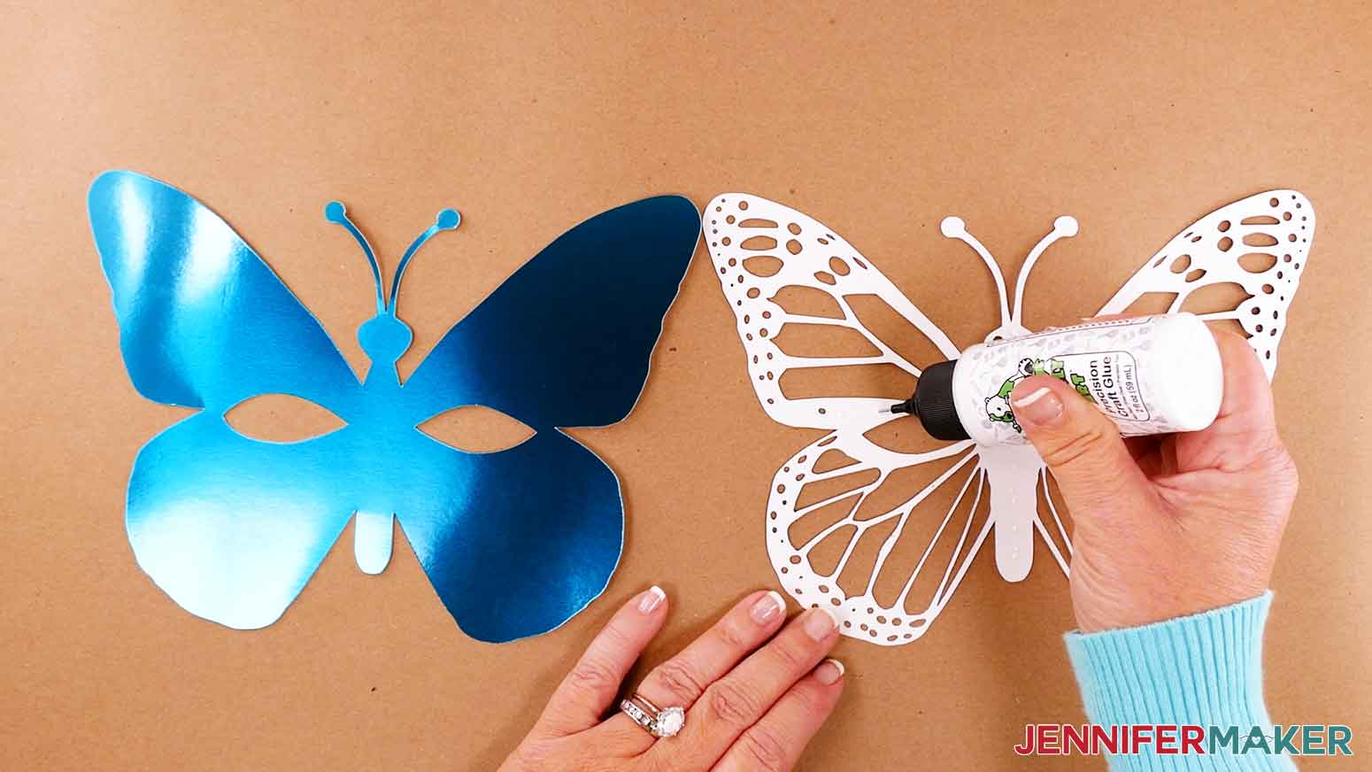 Apply craft glue to the back of the glitter cardstock for the butterfly mask design.