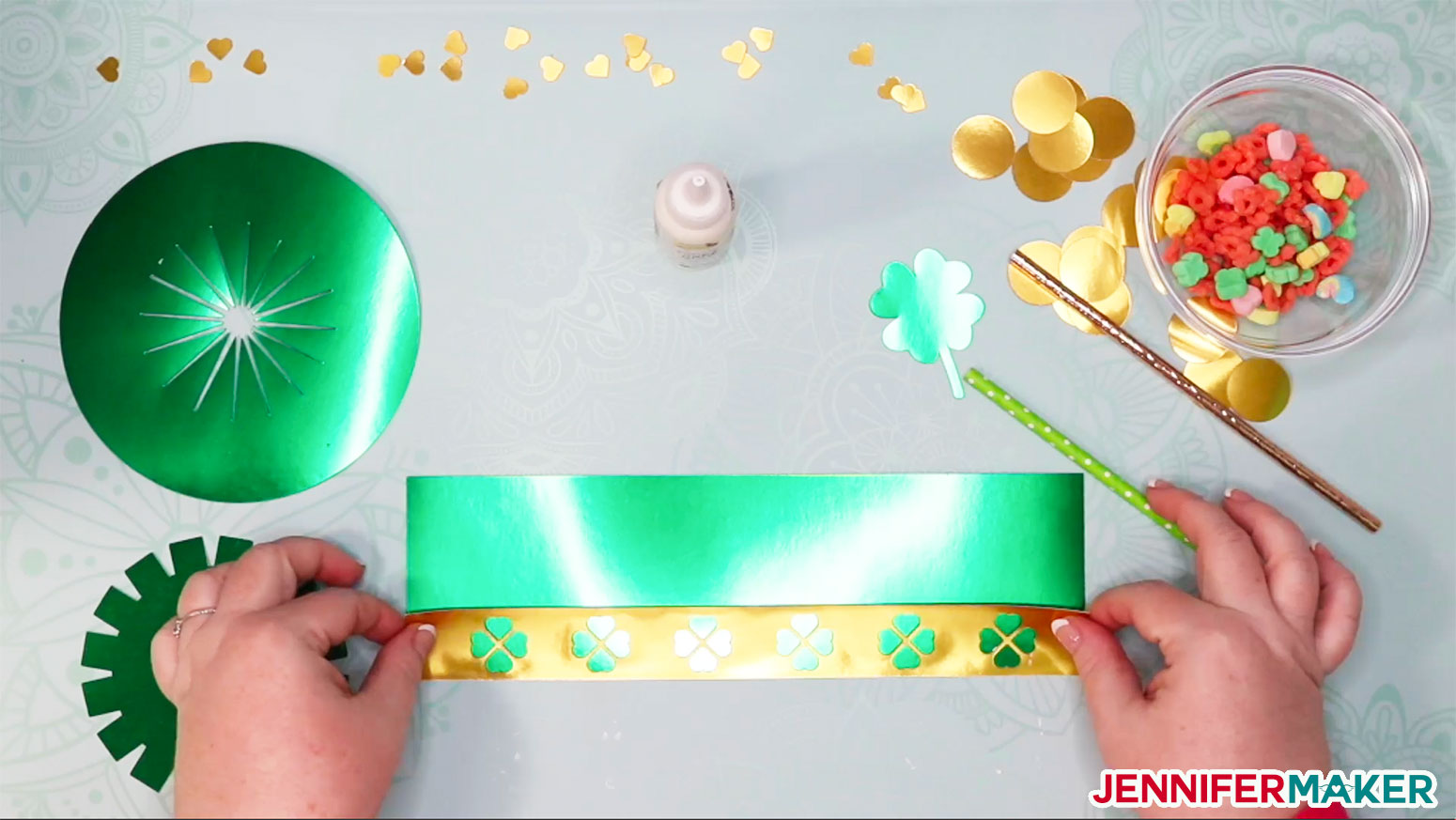 Attaching the gold hat band to the green paper hat to make a DIY paper hat and leprechaun trap